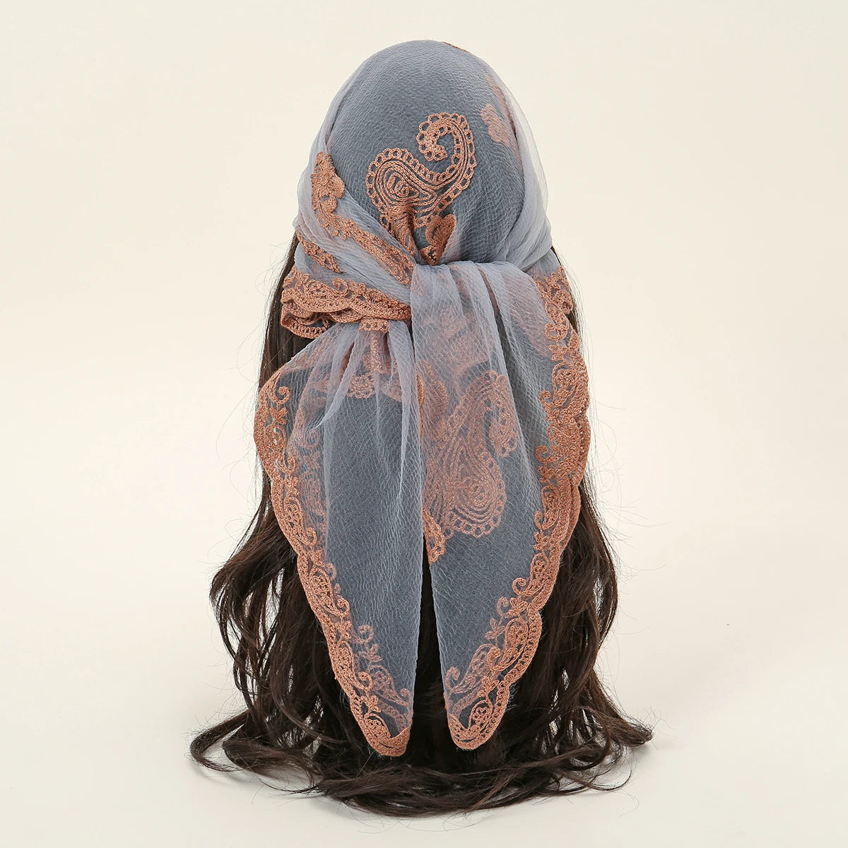 A soft gray floral embroidered lace bandana headscarf tied around dark hair.