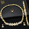 A gold heart crystal jewelry set featuring a necklace and ring displayed on a black background.