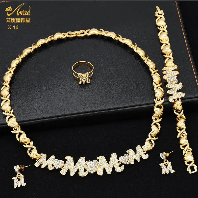 A gold heart crystal jewelry set featuring a necklace and ring displayed on a black background.