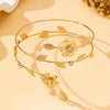 Gold floral vine arm bracelet with small gold leaves and clear stones