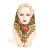 A woman wearing a beige hijab with a vibrant floral print featuring red and green roses and foliage.