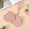 A pink leather pouch for storing portable eyewear, featuring a loop for carrying.