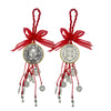 A set of red and gold Saint Benedict protection charms with tassels and ribbons.