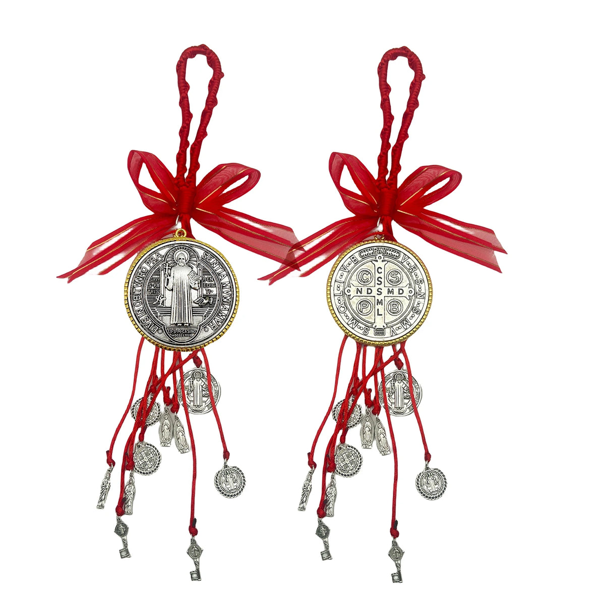 A set of red and gold Saint Benedict protection charms with tassels and ribbons.