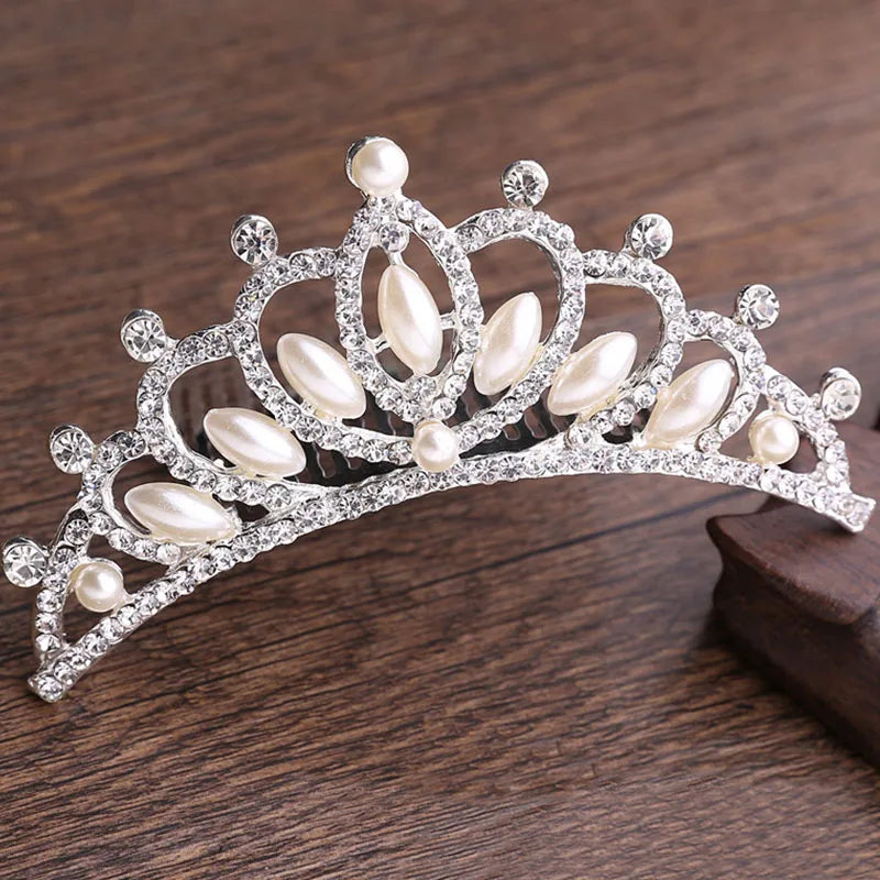 A sparkling crystal princess tiara hair comb featuring pearl and diamond accents.