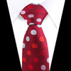 A red silk necktie with a paisley pattern featuring silver and pink polka dots, shown against a white shirt.