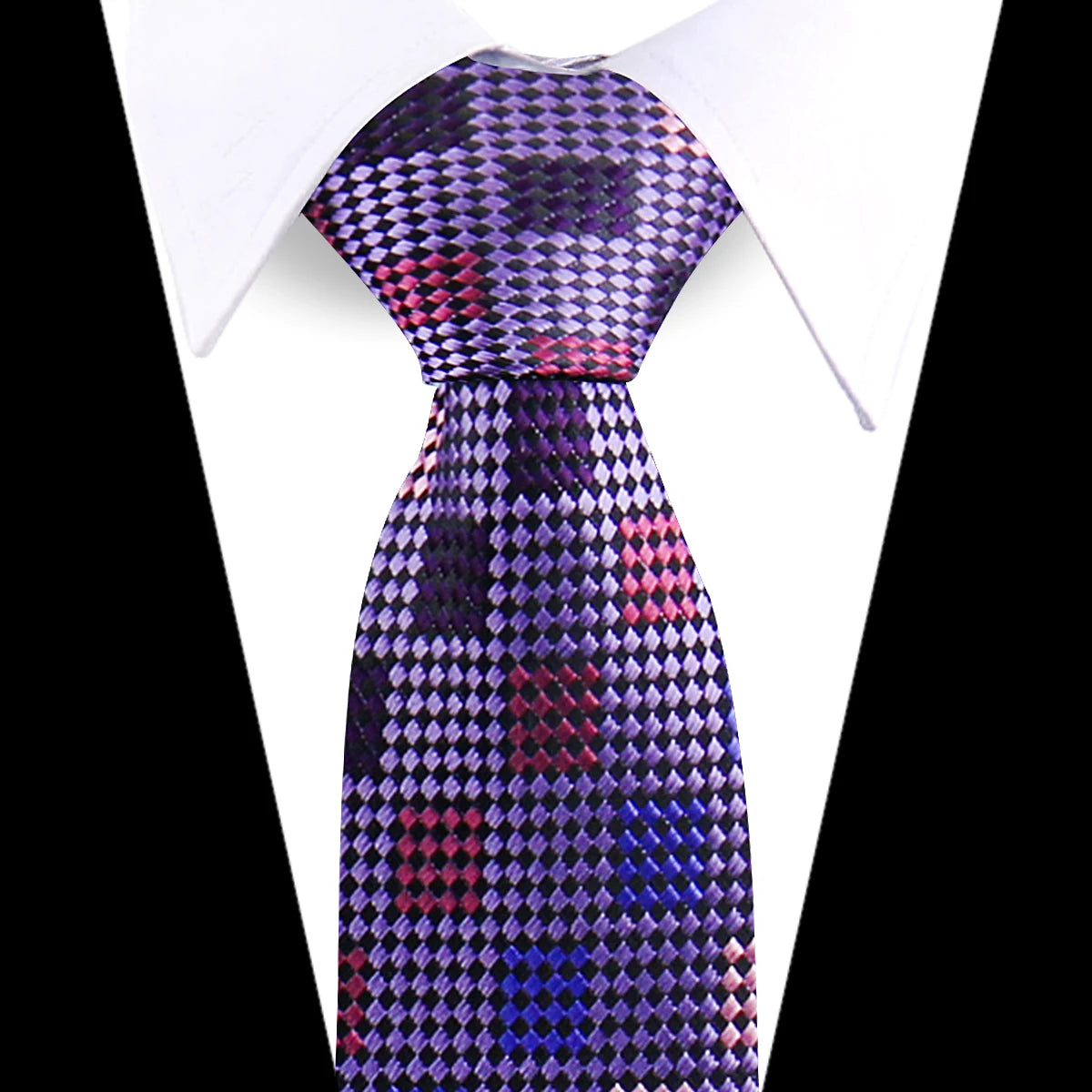 A close-up of an elegant men's floral paisley silk necktie with purple, pink, and blue patterns against a white shirt.