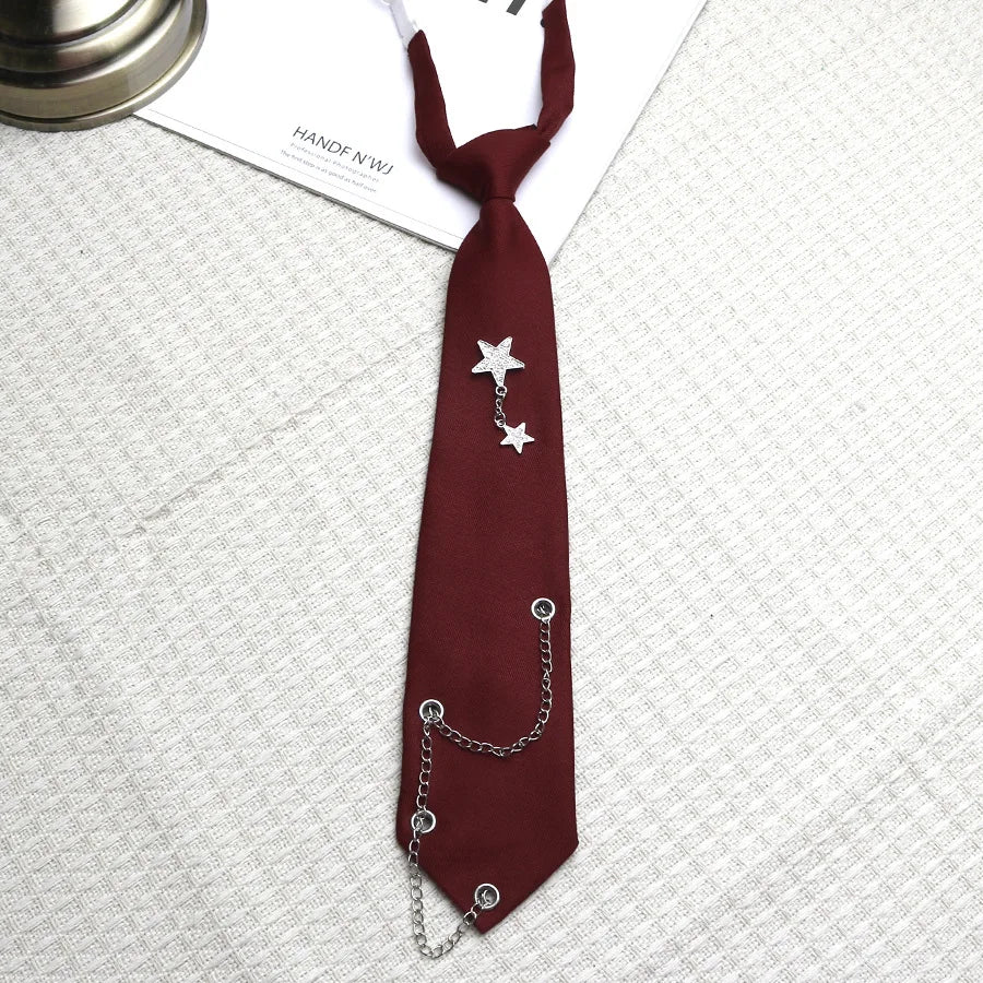 A dark maroon tie featuring a silver chain star accessory for college and trendy accessories.
