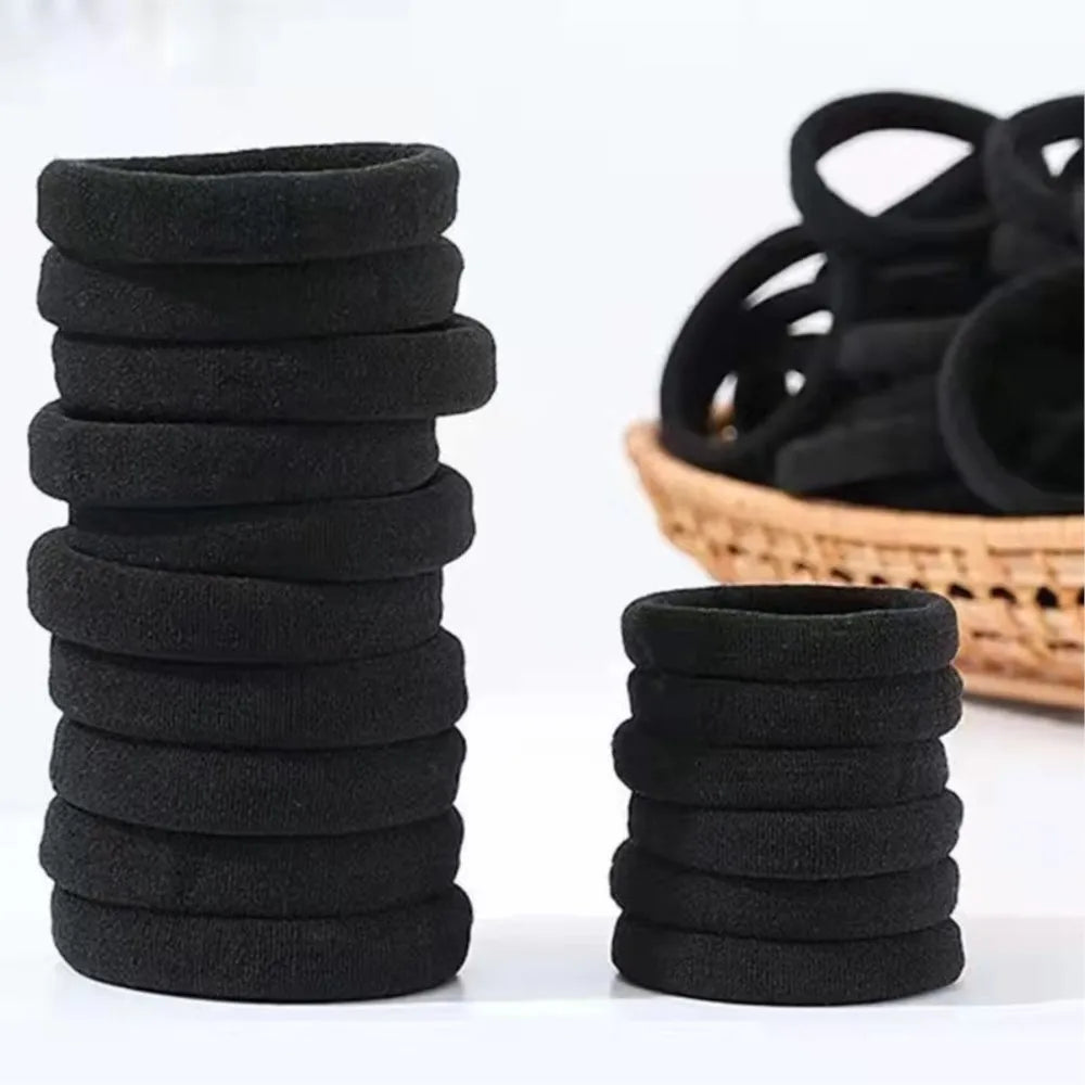 A stack of black seamless hair ties for ponytail holders.
