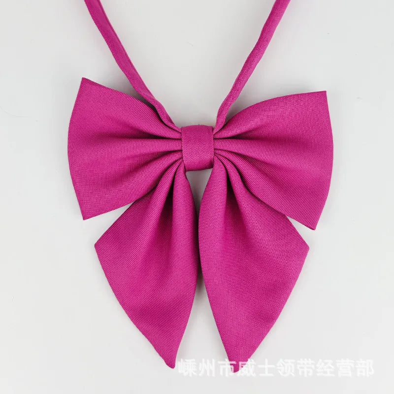 A pink butterfly ribbon tie set featuring a bow design.