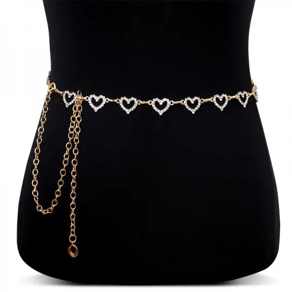 Gold and diamond heart chain body jewelry worn around the waist.