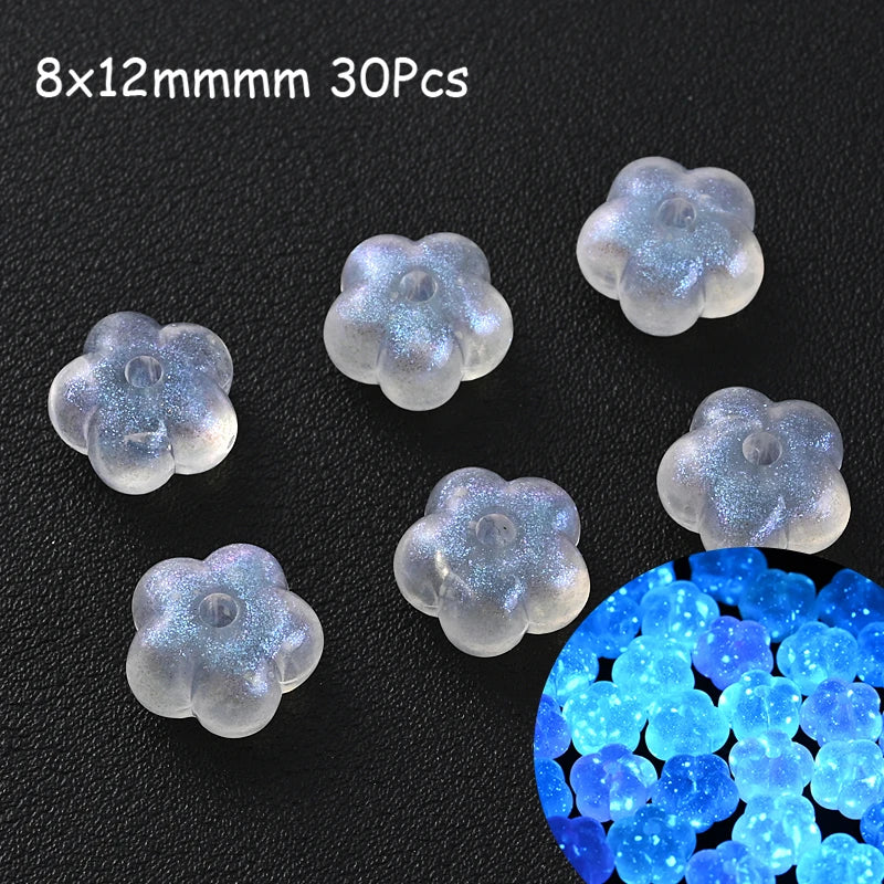 30 pieces of luminous glow-in-the-dark acrylic beads in a cluster and a pile on a black background
