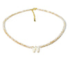 A delicate mother of pearl initial necklace featuring crystal accents.