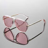 Pink tinted retro large frame sunglasses with thin gold metal arms