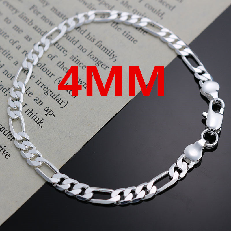 A silver charm necklace and bracelet set displayed on a piece of paper with red text indicating 4mm thickness.