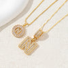 Gold-toned necklace set featuring CZ crystal pendants shaped like the letter N and an initial circle.