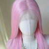 A long straight pink wig displayed on a mannequin, featuring a pearl necklace.