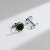 A pair of elegant silver cufflinks with a textured design and a simple bar connector.