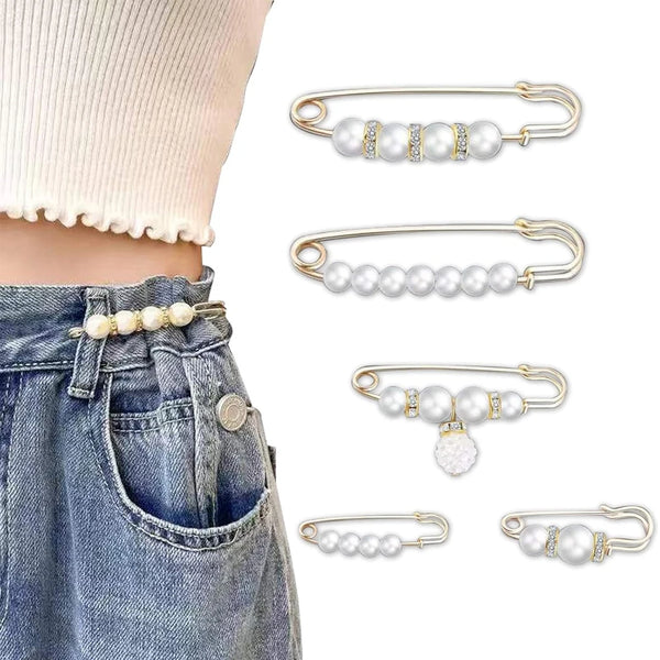 Gold-toned pearl brooch pins and earring findings displayed against a denim background.