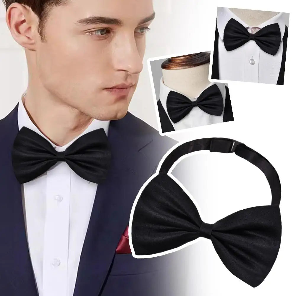 A black knit bow tie shown on a man's shirt and suit jacket.