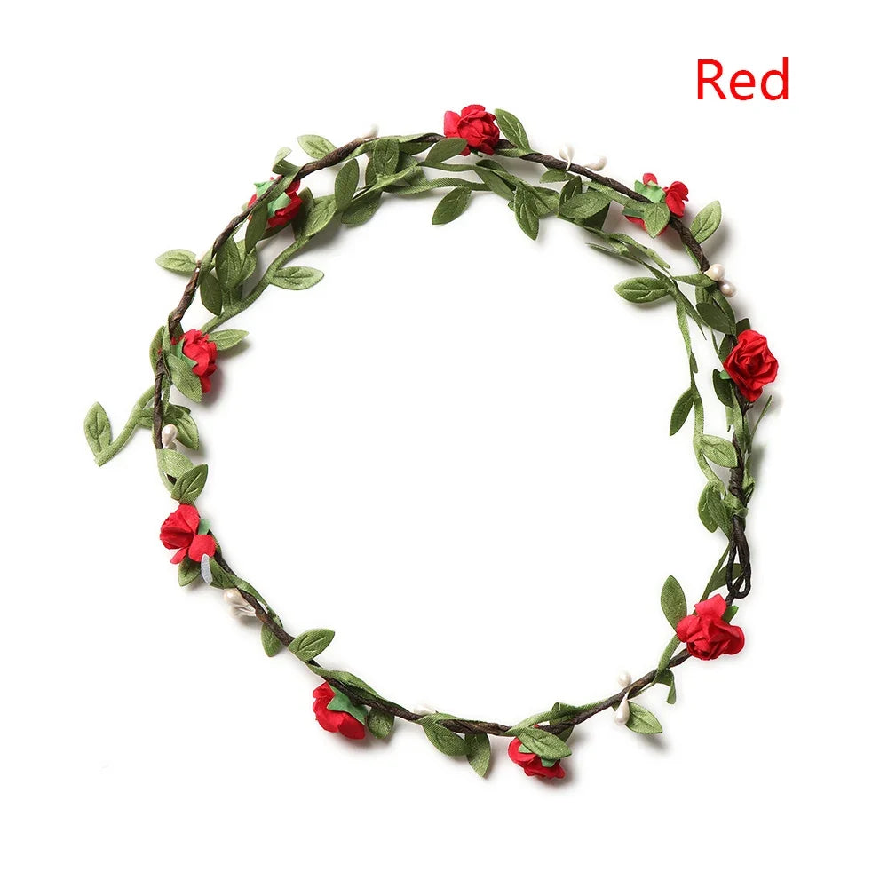 A wreath of red roses and green leaves used as a bohemian flower headband for women.