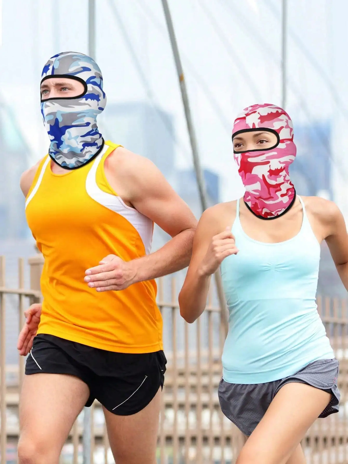 Two people running outdoors wearing colorful balaclava caps and athletic tops.