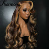 A model wearing a long, wavy brown and honey blonde ombre wig with lace front.