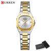 Silberfaruiges Quarz-Armbanduhr mit goldenen Akzenten und Metallarmband, vor weißem Hintergrund.