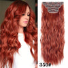 Long, wavy, reddish-orange ombre hair with decorative clips
