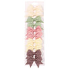 A collection of nine handmade ribbon bow hair clips in pastel shades including cream, mint green, pink, yellow, and mauve.