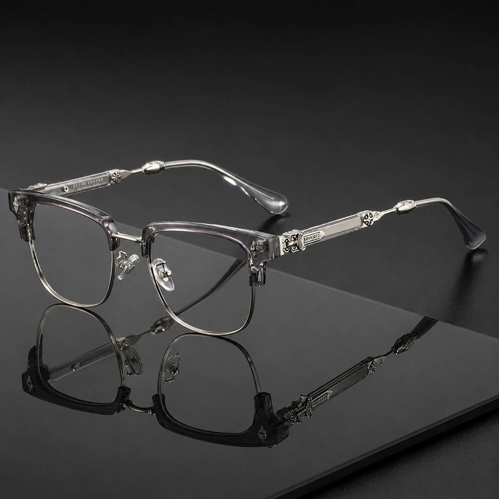 Une paire de lunettes vintage à demi-monture transparentes posée sur une surface sombre avec un reflet.