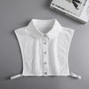 White knitted blouse with a false collar and buttons displayed on a gray background.