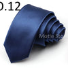 A dark blue satin neck tie folded and displayed against a white background.