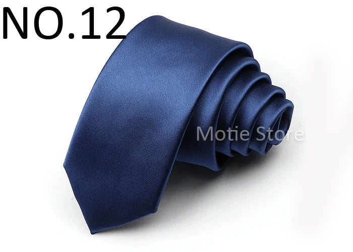 A dark blue satin neck tie folded and displayed against a white background.