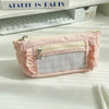 A pink lace pencil case with a clear window and decorative stitching is displayed on a white surface.