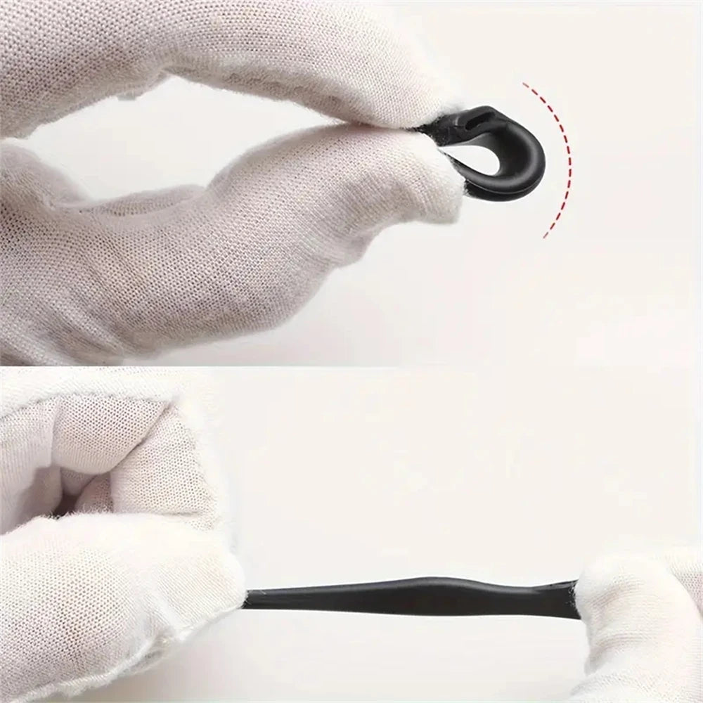 A hand in a white glove is shown gripping a black silicone anti-slip ear hook.