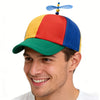 A man wearing a funny multicolor propeller hat with red, yellow, and blue panels.