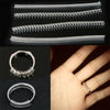 A set of four clear plastic invisible ring size adjusters shown in various arrangements and on a hand.