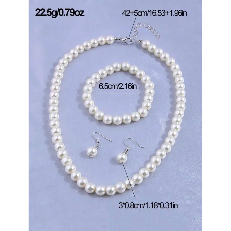 A necklace and pair of earrings made of faux pearls, presented on a light blue background.