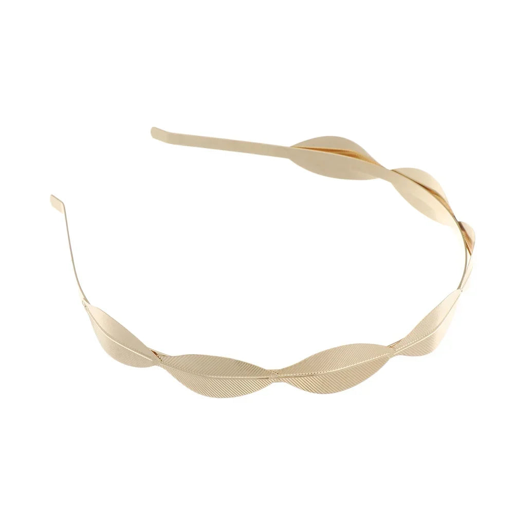 A delicate gold leaf headband for bridal or party wear.