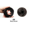 A hand holds a coil of black brown synthetic hair, demonstrating the texture and curl pattern.