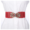 Red vintage leather elastic belt with a brass Celtic knot buckle worn on a white shirt.