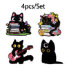 A set of four cute black cat enamel brooches, including a guitar-themed piece.