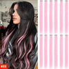 Long dark hair with pink highlights and balayage styled in loose waves