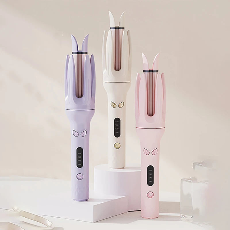 Three professional automatic curling irons in lavender, white, and pink displayed on a white surface.