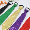 A collection of five sequin ties in black, green, gold, purple, and red laid out on a white surface.
