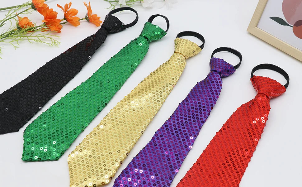 A collection of five sequin ties in black, green, gold, purple, and red laid out on a white surface.