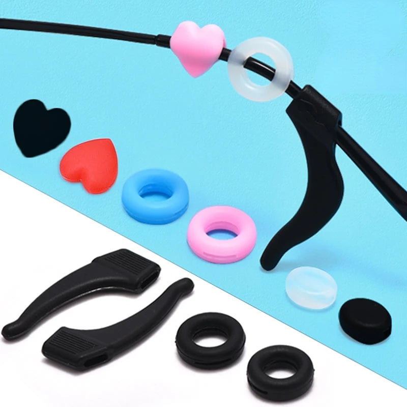 Black silicone ear hooks with pink and white silicone eye hooks displayed on a blue background