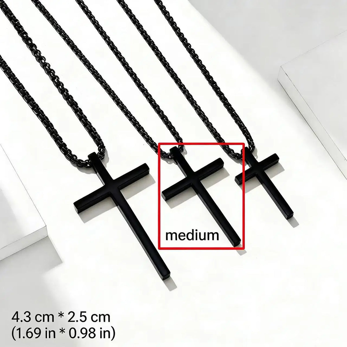 A black stainless steel cross pendant necklace displayed on a white background.