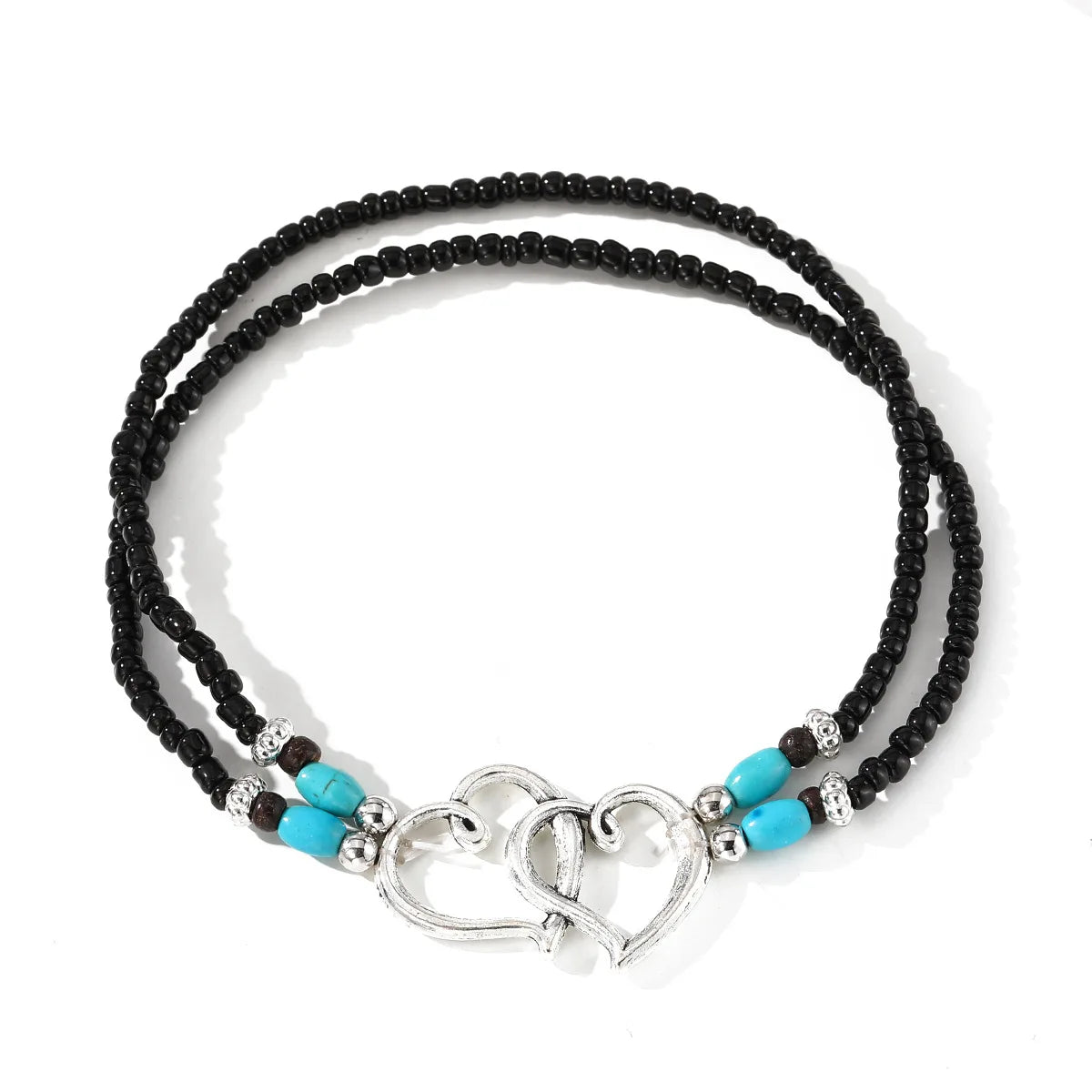 Anillo de tobillo vintage de doble capa con cuentas de corazón, perlas negras y detalles turquesa